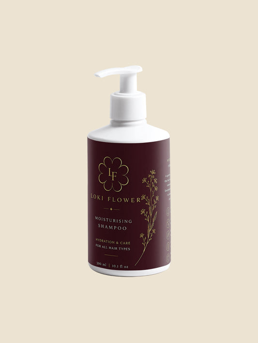 Shampoo bottle with maroon label and white pump on a light gray background